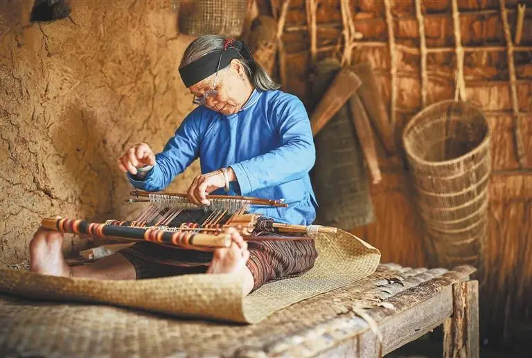 A weaver working at a loom